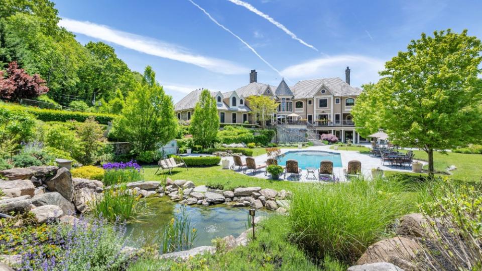 The pool and waterfalls in the backyard - Credit: Douglas Elliman