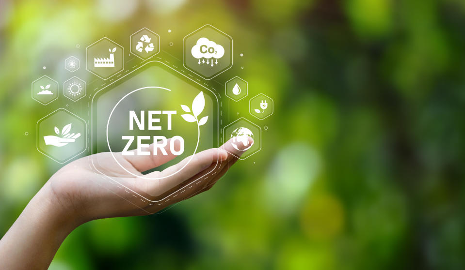 The concept of carbon neutral and net zero. natural environment A climate-neutral long-term strategy greenhouse gas emissions targets with green net center icon on hand cap and green background