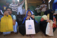 In this Wednesday, April 1, 2020, photo, Rohingya refugees sit at the Kutupalong refugee camp, Cox’s Bazar, Bangladesh. Aid workers are bracing for a possible outbreak of the coronavirus in one of the world's largest refugee camps in Bangladesh, but officials are already warning that containing the disease among more than 1 million tightly packed Rohingya Muslims will be a daunting task. (AP Photo/Suzauddin Rubel)