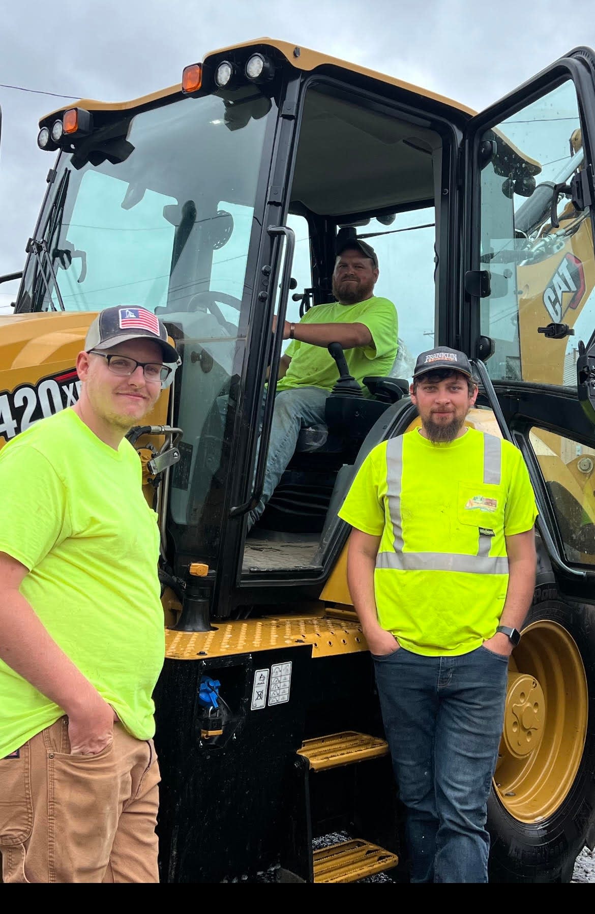 Lane Gribble, in the cab, and Jordan Gallagher of the street department along with Braeden Taylor of the water department, right, cleaned equipment following the recent community cleanup day. Four dumpsters were filled and many village employees jumped in and help as well as other volunteers. The village hopes to plan another cleanup in September.