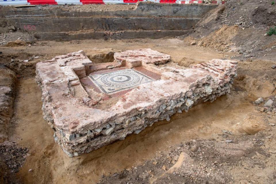 The tomb ruins with the older, lower mosaic visible.