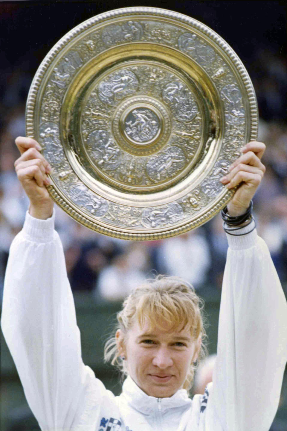 FILE - In this July 9, 1989, file photo, West Germany's Steffi Graf holds up the championship plate on the Centre Court at Wimbledon after defeating Martina Navratilova for the second year in a row. (AP Photo/Dave Caulkin, File)