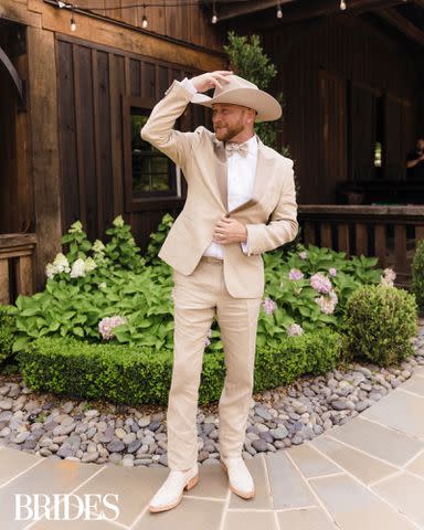 <p>Madison Emily Hare/BRIDES</p> Cole Swindell wears a Hugo Boss tux at his Nashville wedding reception on June 22, 2024