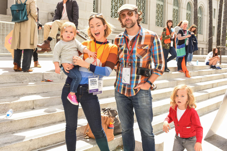 Olivia Wilde with her crew — partner Jason Sudeikis and kids Daisy, almost 2, and Otis, 4 — at March for Our Lives Los Angeles in March 2018. Sudeikis appears in her directorial debut, and she says working with him was “great. I mean, directing a good actor is like driving a Ferrari. They’re very well-tuned, so you make tiny adjustments and they can do anything.” (Photo: Presley Ann/WireImage)