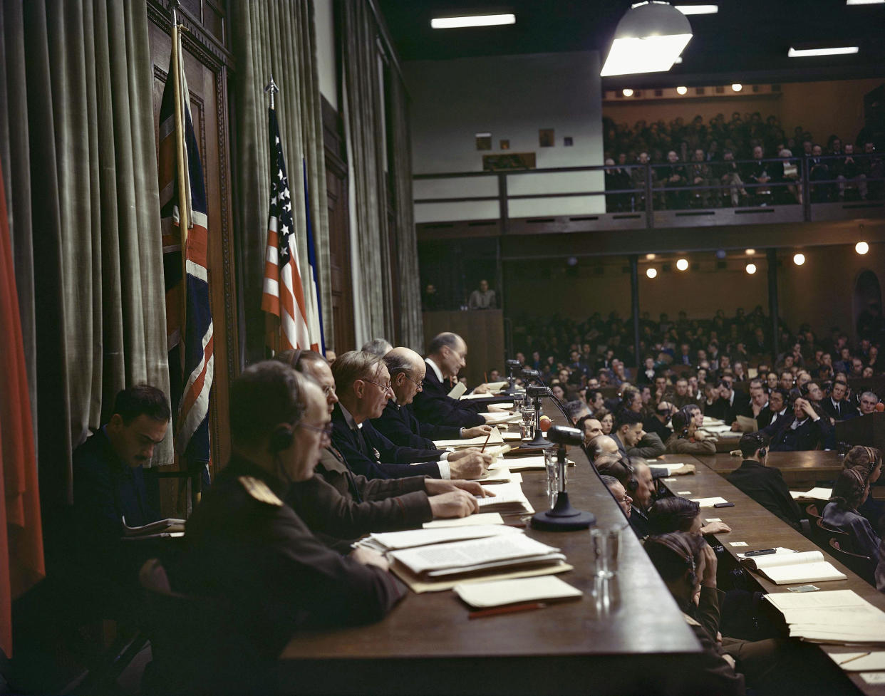 FILE - In this Sept. 30, 1946 file photo, members of the International Military Tribunal read the verdicts in the courtroom of the Palace of Justice in Nuremberg, Germany. Germany marks the 75th anniversary of the landmark Nuremberg trials of several Nazi leaders and in what is now seen as the birthplace of a new era of international law on Friday, Nov. 20, 2020. (AP Photo/Eddie Worth, file)