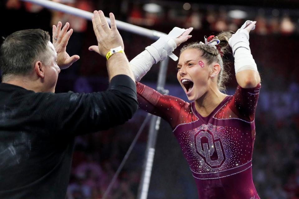 OU's Jordan Bowers celebrates with associate head coach Lou Ball during the NCAA women's gymnastics regionals on April 1 at Lloyd Noble Center in Norman.