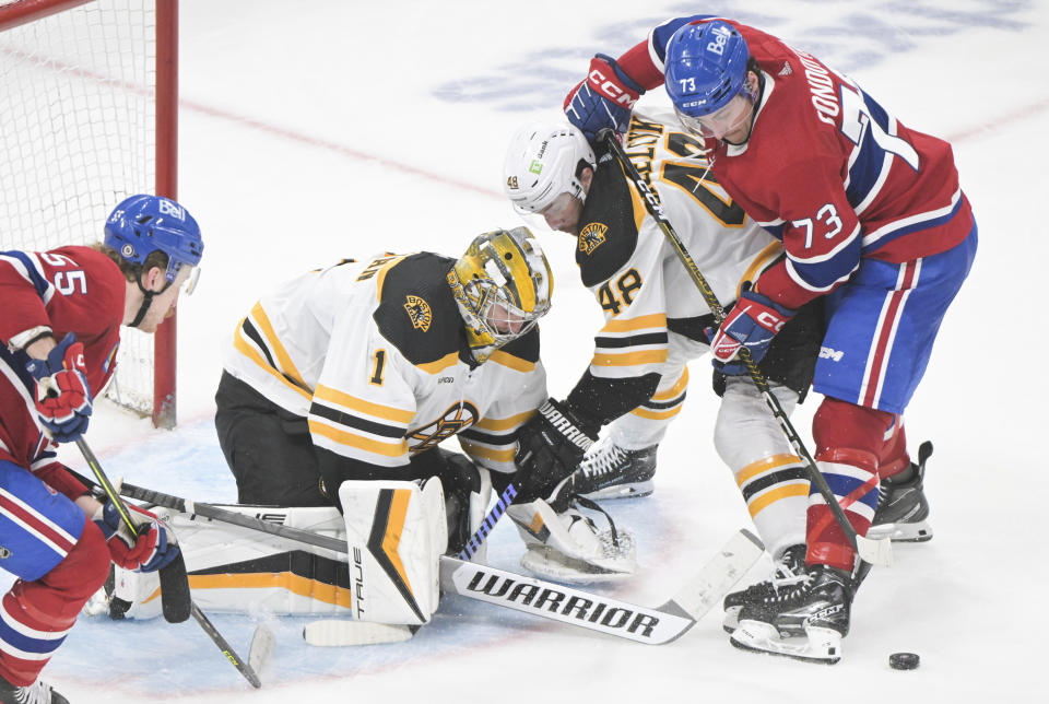 Montreal Canadiens' Lucas Condotta (73) moves in against Boston Bruins goaltender Jeremy Swayman as Bruins' Matt Grzelcyk (48) defends during third-period NHL hockey game action in Montreal, Thursday, April 13, 2023. (Graham Hughes/The Canadian Press via AP)