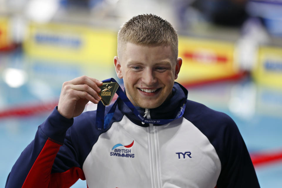 Adam Peaty of Great Britain poses with his gold medal after winning the 100 meters breaststroke men final setting a new world record at the European Swimming Championships in Glasgow, Scotland, Saturday, Aug. 4, 2018. (AP Photo/Darko Bandic)