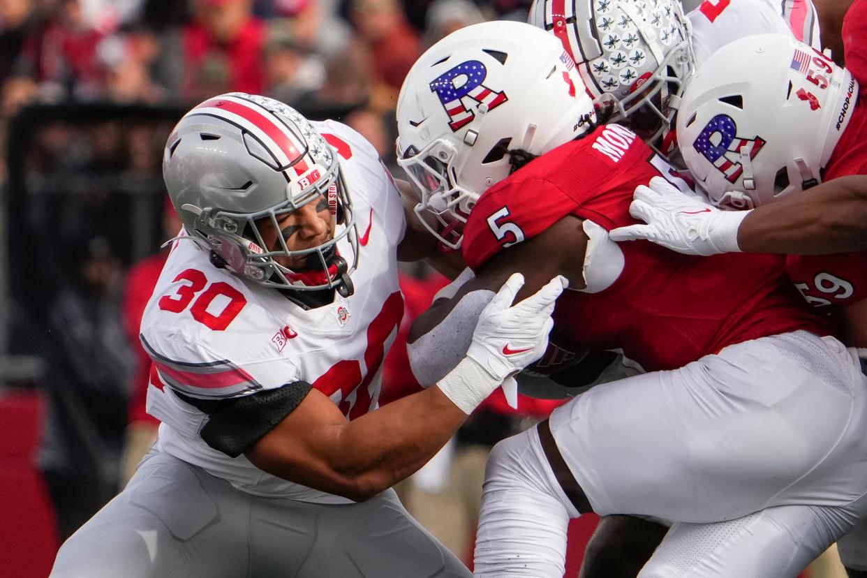 Nov 4, 2023; Piscataway, New Jersey, USA; Ohio State Buckeyes linebacker Cody Simon (30) tackles Rutgers Scarlet Knights running back Kyle Monangai (5) during the NCAA football game at SHI Stadium. Ohio State won 35-16.