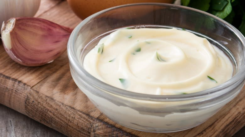 Closeup of a glass dish of homemade aioli