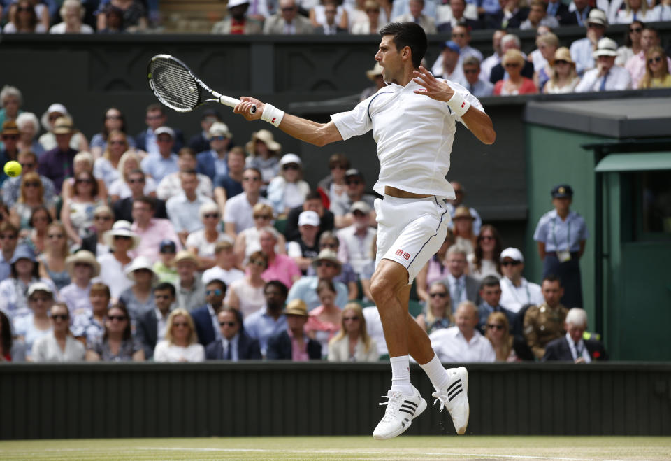 Novak Djokovic of Serbia plays a return to Roger Federer of Switzerland during the men's singles final at the All England Lawn Tennis Championships in Wimbledon, London, Sunday July 12, 2015. (AP Photo/Alastair Grant)