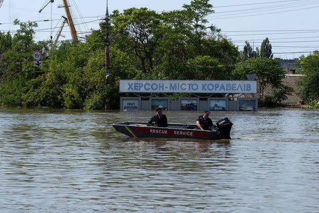 Ukrainian security sails by a placard reading 