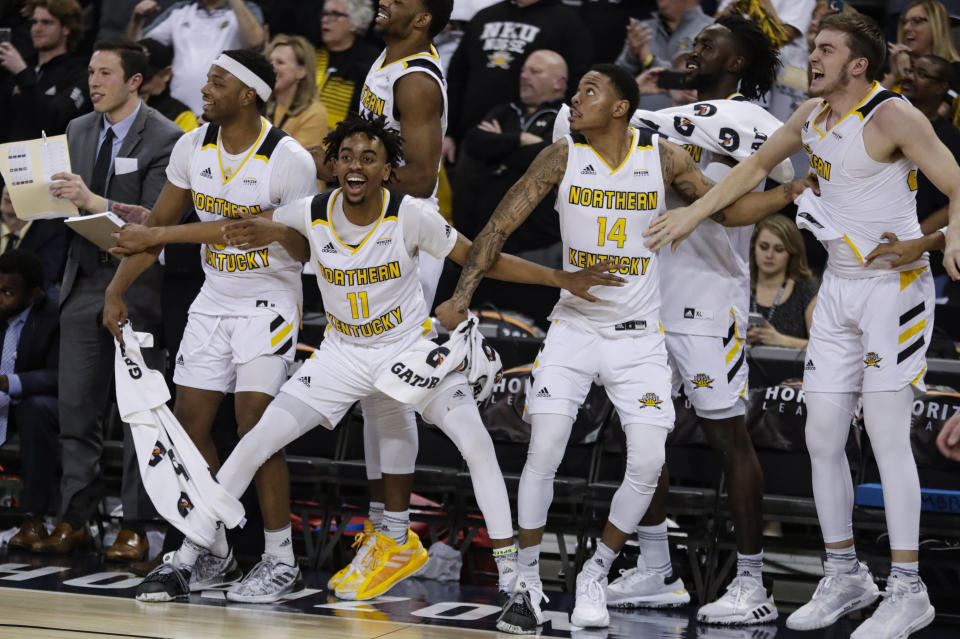 Northern Kentucky's Tre Cobbs, Jalen Tate, Karl Harris (14) and Bryant Mocaby (30), from left, celebrate on the bench during the second half against Illinois-Chicago in an NCAA college basketball game for the Horizon League men's tournament championship in Indianapolis, Tuesday, March 10, 2020. Northern Kentucky won 71-62. (AP Photo/Michael Conroy)
