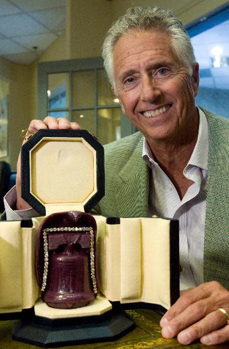 In this photo taken Thursday, Sept. 2, 2010, Jim Stein, owner of Stuart Kingston Jewelers, poses with a custom case holding the Liberty Ruby in Wilmington, Del. The U.S. Attorney's Office says four men have been arrested in connection with the theft of a $2 million ruby during a jewelry store heist in Wilmington, Del. Spokeswoman Kimberlynn Reeves said an indictment that had been returned in December against the suspects was unsealed Thursday, Feb. 20, 2014 after their arrest. The four are accused of robbing Stuart Kingston Jewelers in November 2011 and escaping with $4.4 million in jewelry, including the 5-inch, 4-pound Liberty Bell Ruby, made from the largest mined ruby in the world. The indictment says the armed, masked men restrained store employees with zip ties and duct tape and smashed glass display cases with hammers. Reeves said none of the jewelry has been recovered.(AP Photo/The Wilmington News-Journal, William Bretzger)