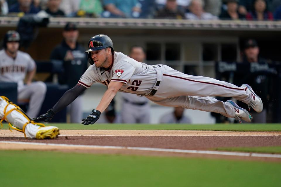 The Arizona Diamondbacks' Josh Reddick, a South Effingham High School graduate, slides in safely to home during a game against the Padres on June 26, 2021, in San Diego.