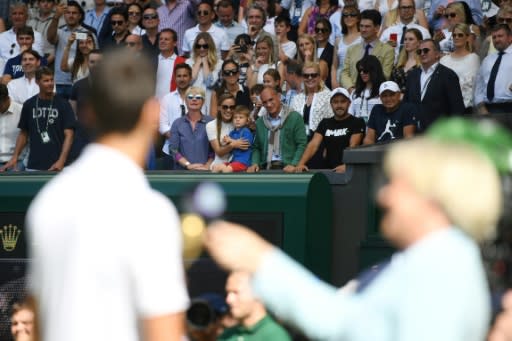 Family affair: Djokovic looks at his wife Jelena and son Stefan