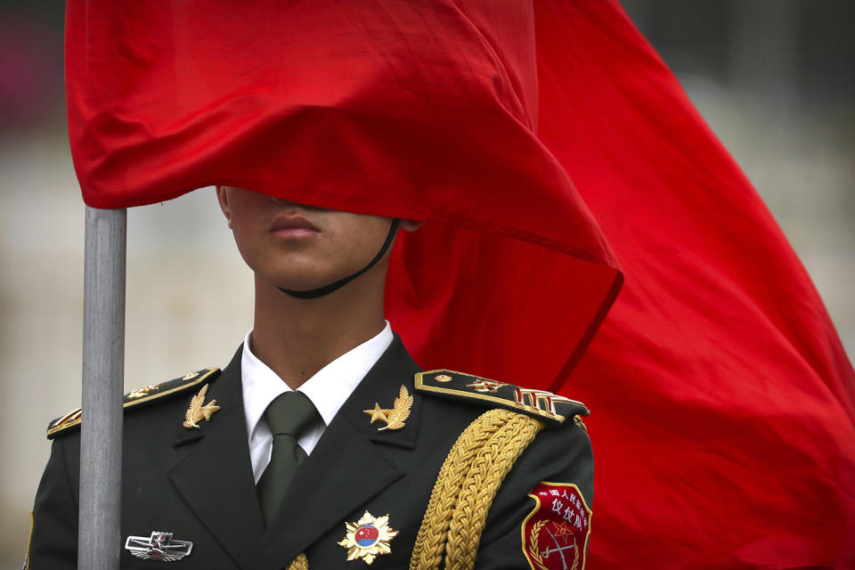 Ceremonial flag blows across honor guard members face