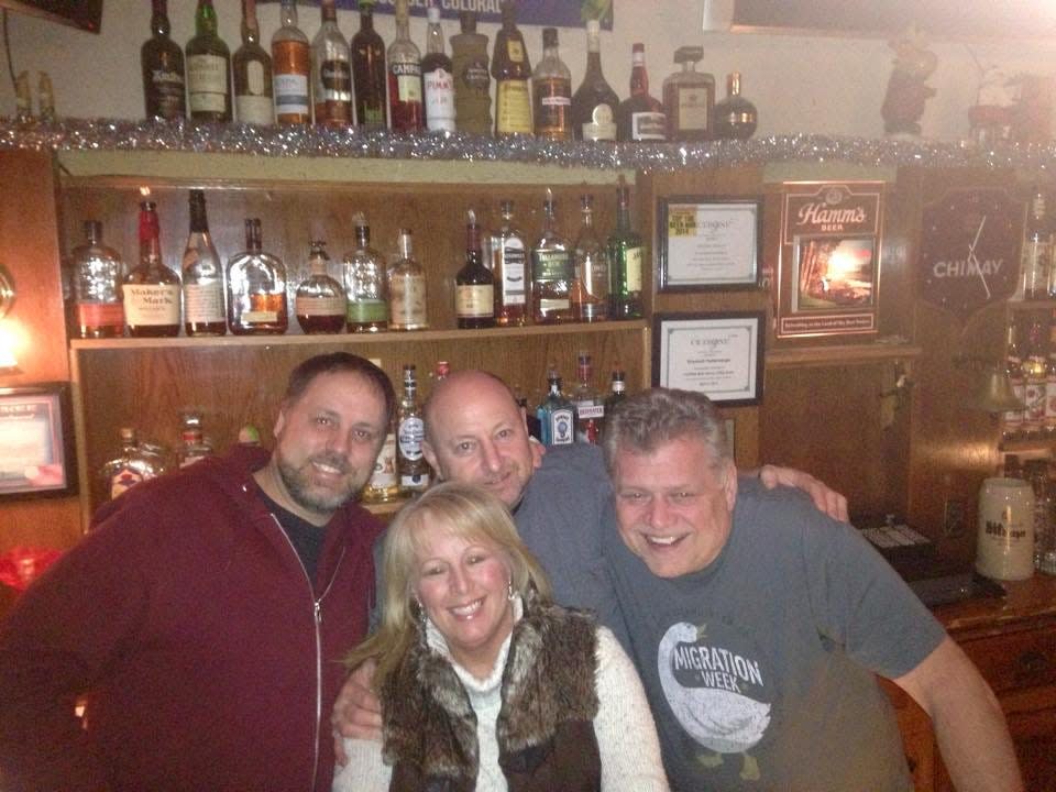 Mike Romans, right, poses for a photo with Brian Johnson, from left, Wade Grubich and Chris Lisiak at Romans' Pub.