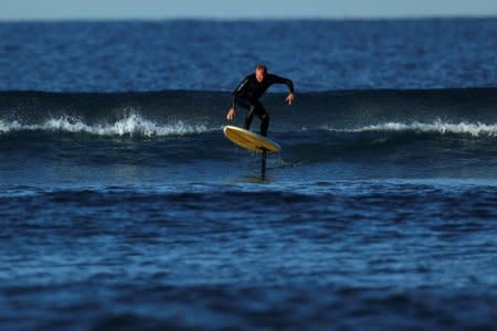 Surfer Gary Clisby rides a foil board on a swell off the coast of Del Mar, California, U.S., February 3, 2018. Picture taken February 3, 2018.   REUTERS/Mike Blake