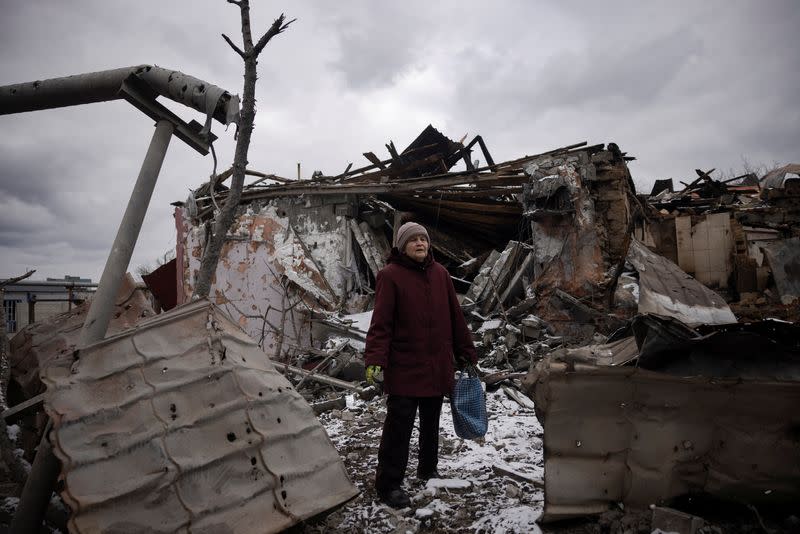 Nadezhda Prokopenko stands in front of the house of a relative that was destroyed in a Russian missile strike in Selydove near Avdiivka