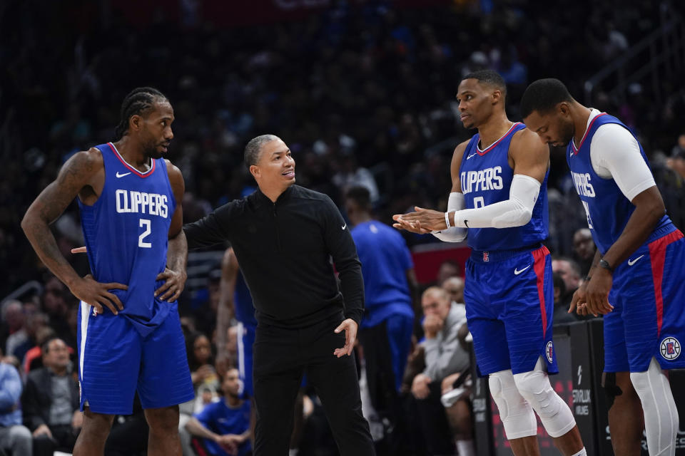 Los Angeles Clippers head coach Tyronn Lue, second from left, speaks with forward Kawhi Leonard and guards Russell Westbrook and Norman Powell, from left, during the second half of an NBA basketball game against the Denver Nuggets, Monday, Nov. 27, 2023, in Los Angeles. (AP Photo/Ryan Sun)