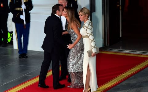 President Donald Trump and first lady Melania Trump greet French President Emmanuel Macron and his wife Brigitte Macron as they arrive for a State Dinner at the White House - Credit: AP