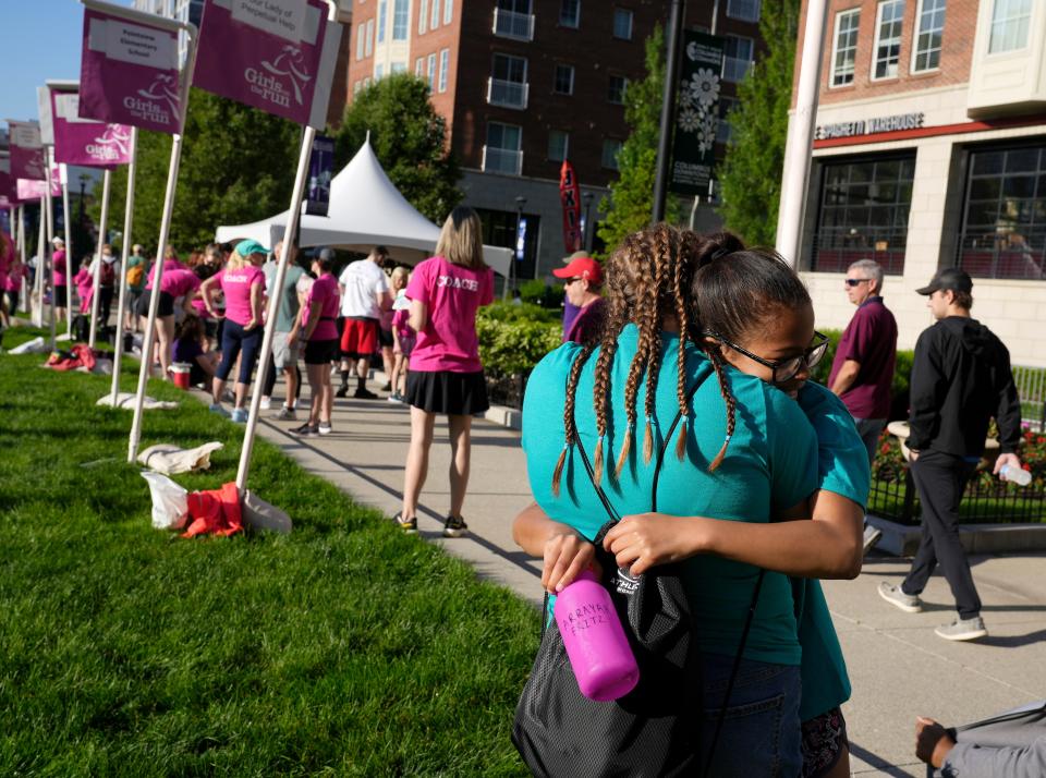Marquita Wickman and Arrayah Fritz of the Ohio School for the Deaf embrace before the Girls on the Run spring 5K on Sunday.
