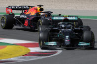 Mercedes driver Valtteri Bottas of Finland takes a curve followed by Red Bull driver Max Verstappen of the Netherlands during the Portugal Formula One Grand Prix at the Algarve International Circuit near Portimao, Portugal, Sunday, May 2, 2021. (AP Photo/Manu Fernandez)