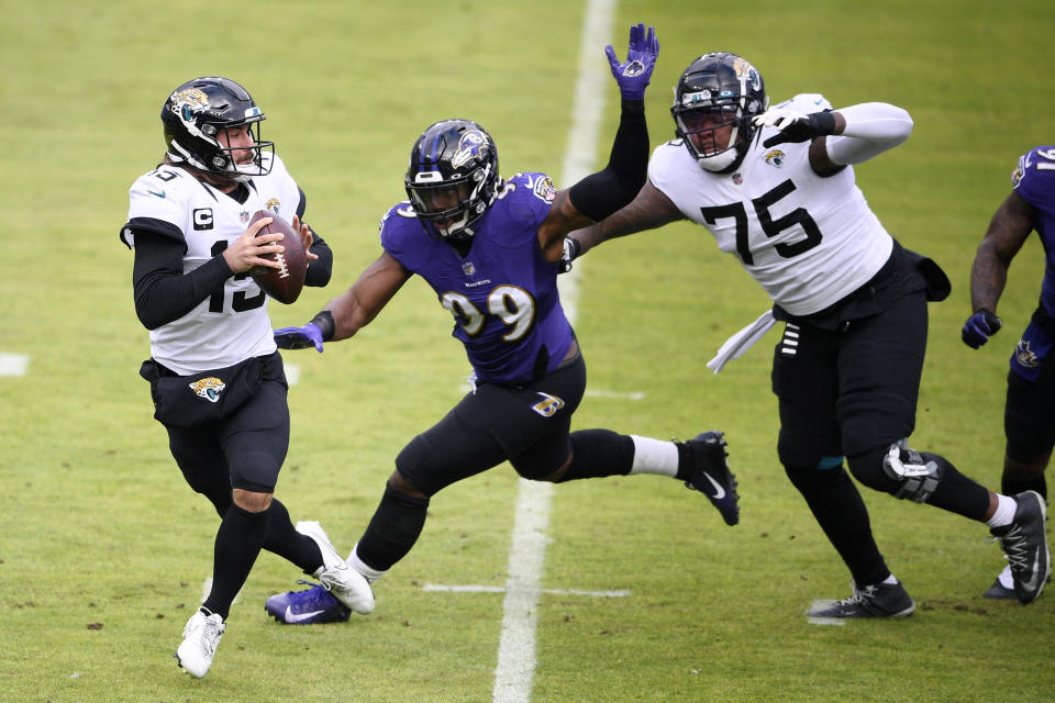 Baltimore Ravens linebacker Matthew Judon (99) gets by Jacksonville Jaguars offensive tackle Jawaan Taylor (75) as quarterback Gardner Minshew II (15) looks to throw a pass during the first half of an NFL football game, Sunday, Dec. 20, 2020, in Baltimore. (AP Photo/Nick Wass)