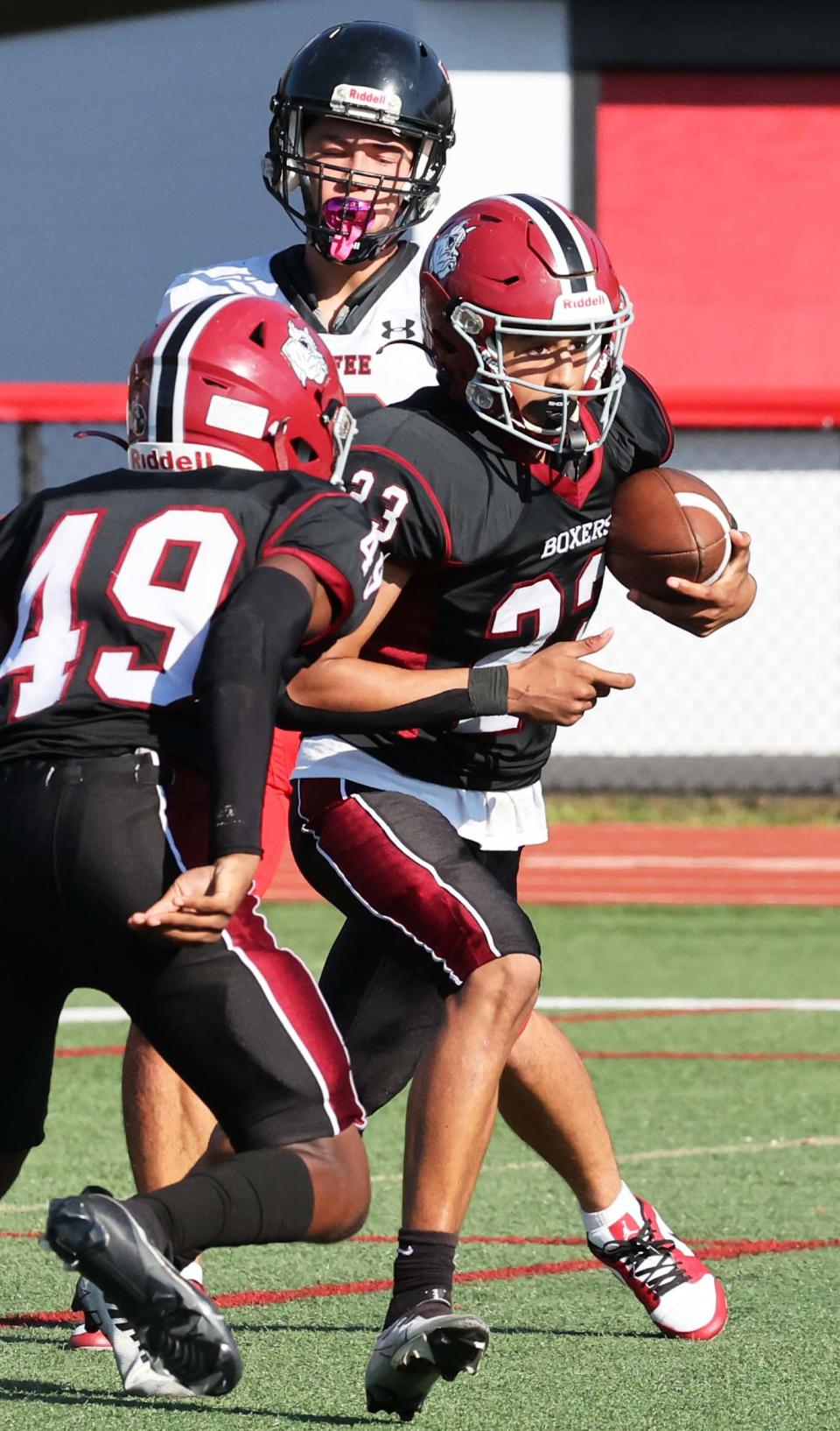 Brockton defender Jarred Mighty makes the interception catch and runs in back for a touchdown during a game versus Durfee on Saturday, October 28, 2023.