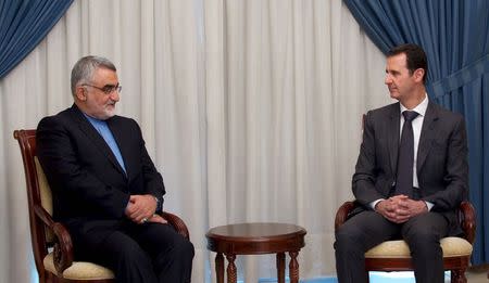 Syria's President Bashar al-Assad meets with Alaeddin Boroujerdi (L), Chairman of Iranian Parliament's National Security and Foreign Policy Commission, in Damascus, in this handout provided by SANA on May 13, 2015. REUTERS/SANA/Handout via Reuters