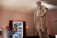 NEW YORK, NY - SEPTEMBER 19: A man photographs the iconic 13-foot statue of Christopher Columbus is viewed from the 810-square-foot "living room" art installation by Japanese artist Tatzu Nishi on September 19, 2012 in New York City. Viewed as a piece of conceptual art, "Living Room", which sits 70-feet above ground level and is only accessible via a scaffold-encased staircase, has been temporarily built around the Columbus Monument in Columbus Circle. Beginning Thursday, up to 25 people at a time can enter the living room to view up close the 1892 marble figure of the Italian explorer. (Photo by Spencer Platt/Getty Images)