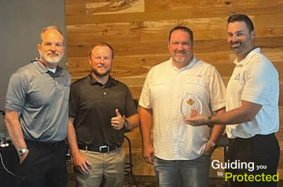 GAF representative Morkan Kirk awards Northpoint Roofing Systems owners Keith Priddy, Joe Happe IV, and Joe Happe III with GAF Triple Excellence Award.