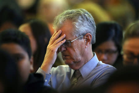 A man mourns during an interfaith memorial service for victims of the Route 91 music festival mass shooting outside the Mandalay Bay Resort and Casino in Las Vegas, Nevada, U.S. October 2, 2017. REUTERS/Lucy Nicholson