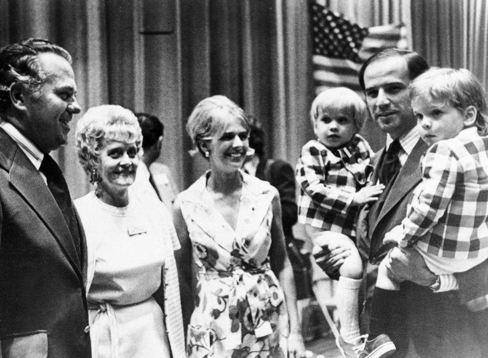 FILE - In this summer 1972 file photo, Joe Biden, carries both of his sons, Joseph, left, and Robert during an appearance at the Democratic state convention At center is his wife Neilia Biden, who was killed in an auto crash, Dec. 20, 1972. With them are Gov.-elect Sherman W. Tribbitt and his wife, Jeanne. (AP Photo)