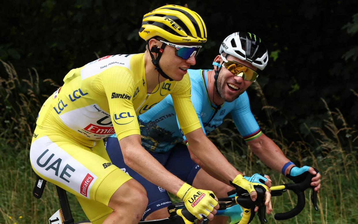 UAE Team Emirates team's Slovenian rider Tadej Pogacar wearing the overall leader's yellow jersey and Astana Qazaqstan Team's British rider Mark Cavendish (R) cycle during the 5th stage of the 111th edition