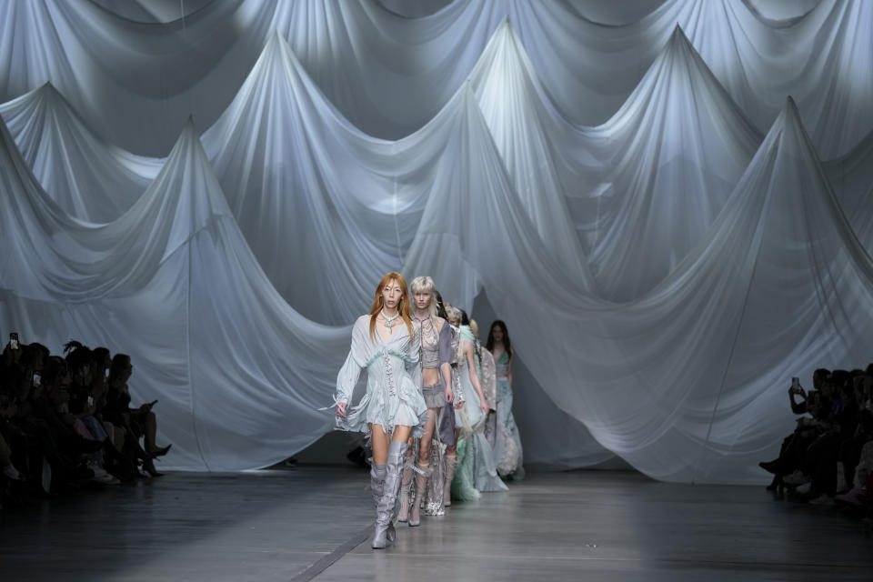 Models wear creations as part of the Aniye Records women's Fall-Winter 2023-24 collection presented in Milan, Italy, Sunday, Feb. 26, 2023. (AP Photo/Antonio Calanni)