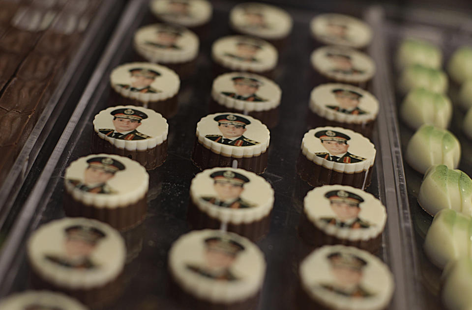 FILE - This Sept. 14, 2013, file photo shows chocolates decorated with pictures of Egyptian Defense Minister Gen. Abdel-Fattah el-Sissi displayed for sale in a shop in Cairo. Egypt's military chief is looking for a strong turnout in next week's nationwide constitutional referendum as a mandate on whether he should run for president, senior officials tell the AP. The popular general who ousted President Mohammed Morsi and ordered a crackdown on the Muslim Brotherhood could be disappointed as his Islamist foes have promised a boycott and mass demonstrations raising fears of violence that are likely to keep voters at home.(AP Photo/Khalil Hamra, File)