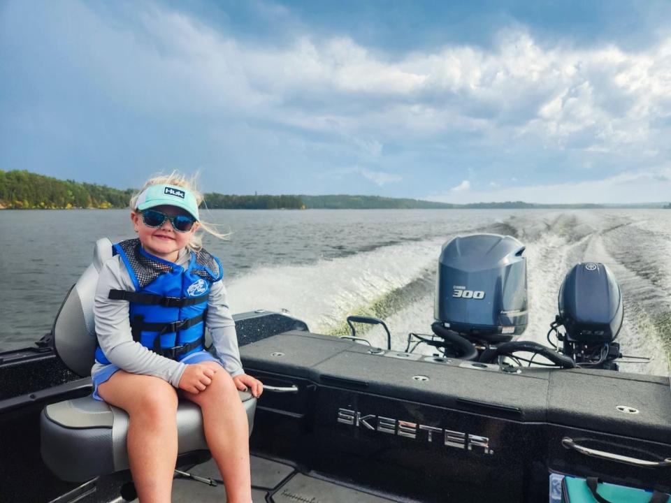 Henley Wollak, 5, rides aboard her dad's boat on Lake Michigan. This summer, she and her dad discovered the long-lost wrecked George L. Newman.