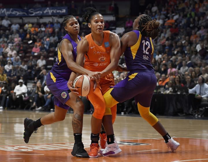 Los Angeles Sparks' Tierra Ruffin-Pratt, left, and Chelsea Gray, right, pressure Connecticut Sun's Alyssa Thomas, center, during the first half of Game 2 of a WNBA basketball playoff game Thursday, Sept. 19, 2019, in Uncasville, Conn. (AP Photo/Jessica Hill)