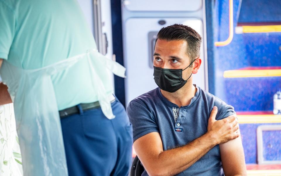 Anthony Ezziane, 41, receiving his vaccination on the Covid bus, Celtic Park, Glasgow - Stuart Nicol 