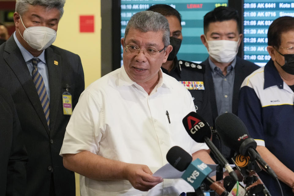 Foreign Minister Saifuddin Abdullah speaks during a press conference after Malaysian youths rescued from human traffickers in Cambodia arrived at the Kuala Lumpur Airport Terminal in Sepang, Malaysia, Friday, Sept. 9, 2022. Saifuddin urged Malaysians to be wary of offers of lucrative jobs and free holidays, as he brought back the two dozen youths. (AP Photo/Vincent Thian)