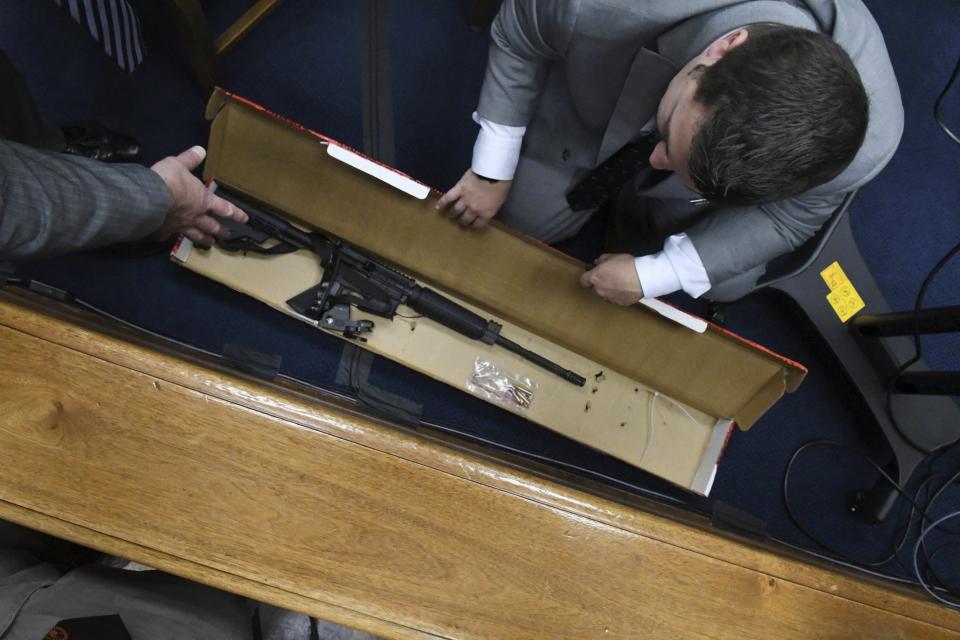 Mark Richards, Kyle Rittenhouse's lead attorney, left, and Kenosha Police Department Detective Ben Antaramian, center, look at the weapon Rittenhouse used on the night of Aug. 25, 2020, during the trial at the Kenosha County Courthouse in Kenosha, Wis., on Tuesday, Nov. 9, 2021. Rittenhouse is accused of killing two people and wounding a third during a protest over police brutality in Kenosha, last year. (Mark Hertzberg /Pool Photo via AP)