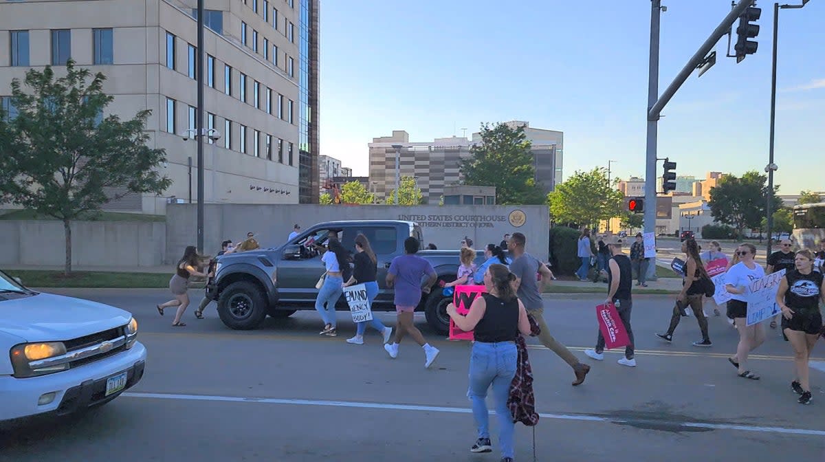 Protesters approach a pickup truck that attempted to run over abortion-rights protesters, in Cedar Rapids, Iowa, US  (Isacc Davis via REUTERS)