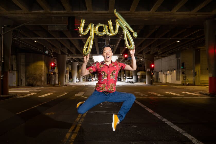 Los Angeles, CA - March 30: Actor, comedian, playright and motivational speaker, Aidan Park, is photographed along Grand Lower, in downtown Los Angeles, CA, Thursday, March 30, 2023. Park has used his life experiences to help motivate others, creating his Yay! Foundation, with the goal of empowering people to overcome grief and sadness in their lives. Park wanted to contrast his bright and colorful life-outlook, with the dark background of the lower Grand Ave area in downtown L.A. (Jay L. Clendenin / Los Angeles Times)