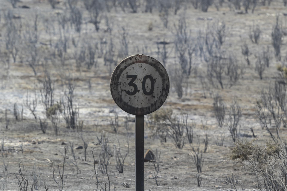 A charred traffic sign after a wildfire near Altura, eastern Spain, on Friday, Aug. 19, 2022. Up to early August, 43 large wildfires — those affecting at least 500 hectares (1,235 acres) — were recorded in the Mediterranean country by the Ministry for Ecological transition, while the average in previous years was 11. The European Forest Fire Information System estimates a burned surface of 284,764 hectares (704,000 acres) in Spain this year. That's four times higher than the average since records began in 2006. (AP Photo/Alberto Saiz)