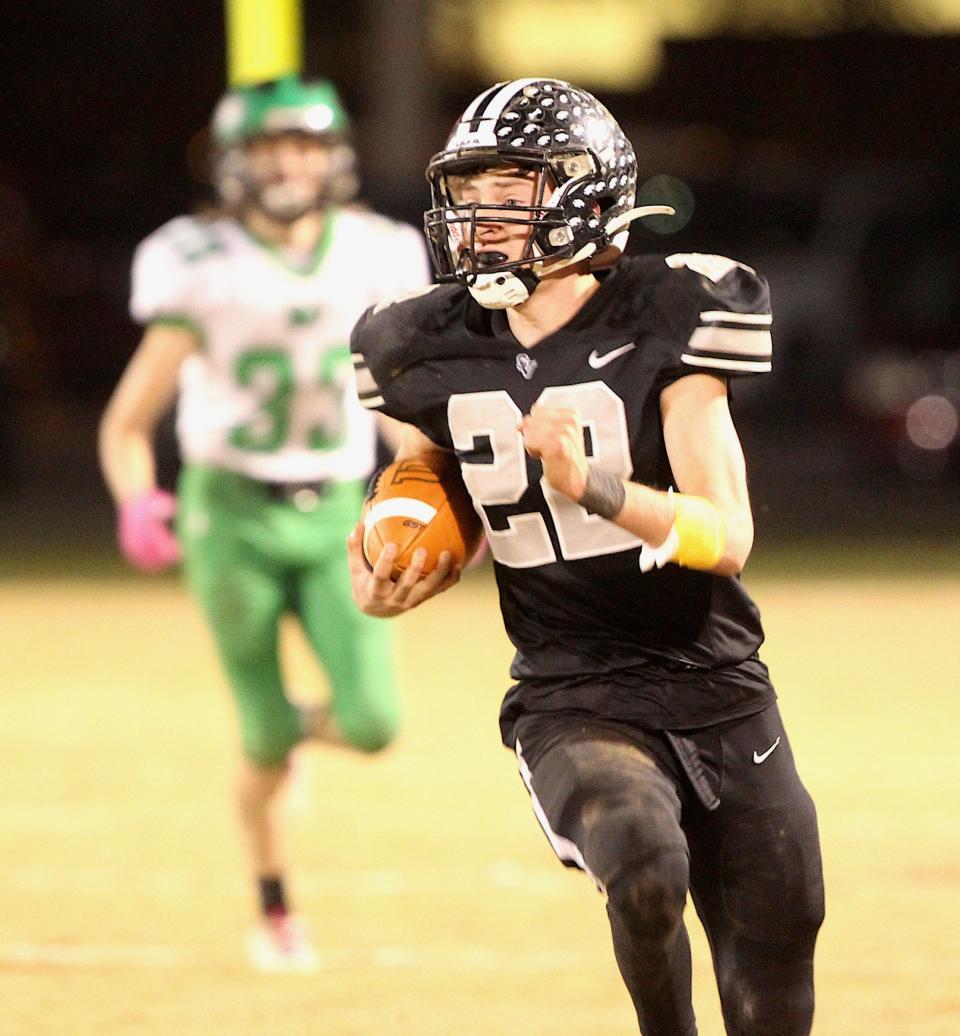 Springs Valley quarterback Kannon Chase (22) runs a punt all the way back for a touchdown during the game against North Central (Farmersburg) on Friday, Nov. 5, 2021.