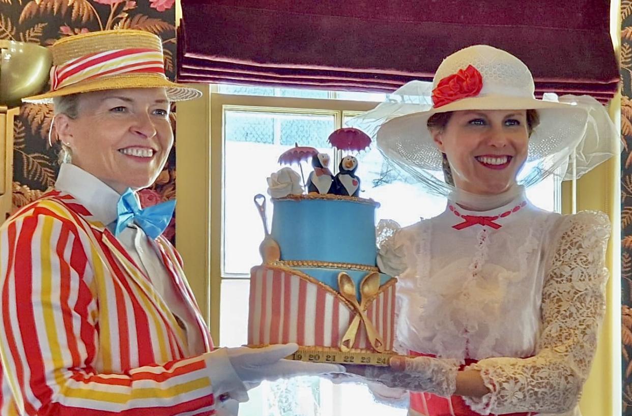 The wedding cake was decorated with two small penguins holding umbrellas