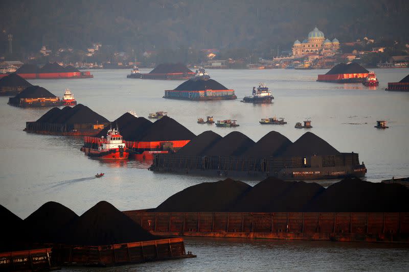 FILE PHOTO: FILE PHOTO: Coal barges are pictured as they queue to be pull along Mahakam river in Samarinda, East Kalimantan province