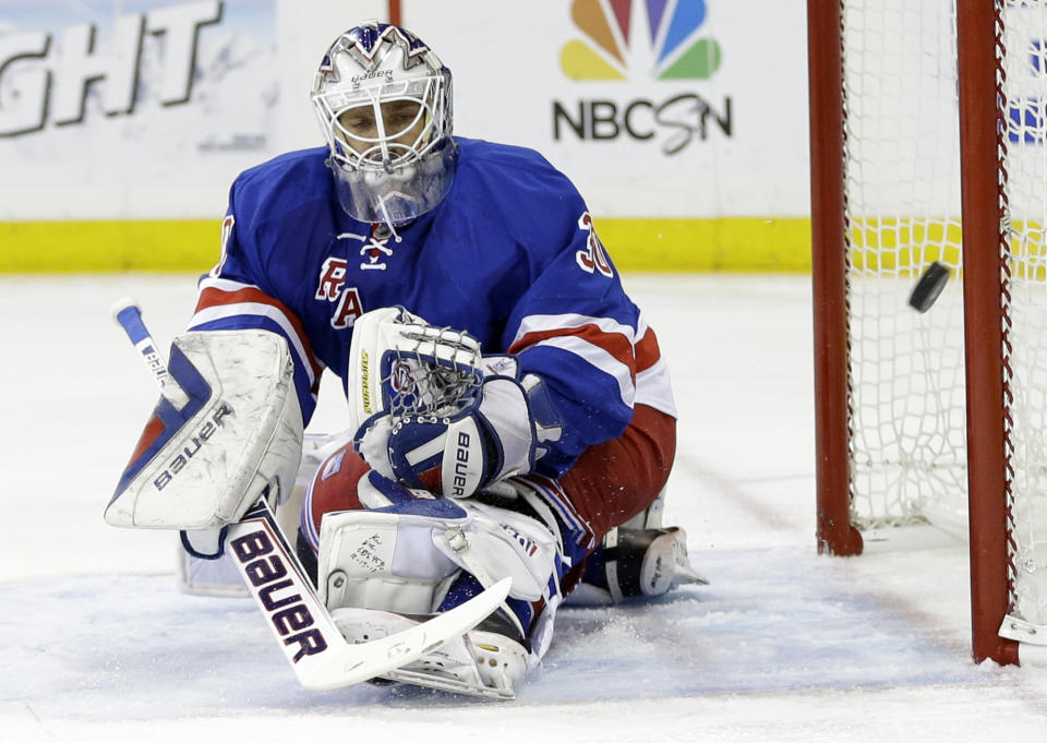 New York Rangers goalie Henrik Lundqvist, of Sweden, deflects a shot on goal during the first period against the Philadelphia Flyers in Game 7 of an NHL hockey first-round playoff series on Wednesday, April 30, 2014, in New York. (AP Photo)